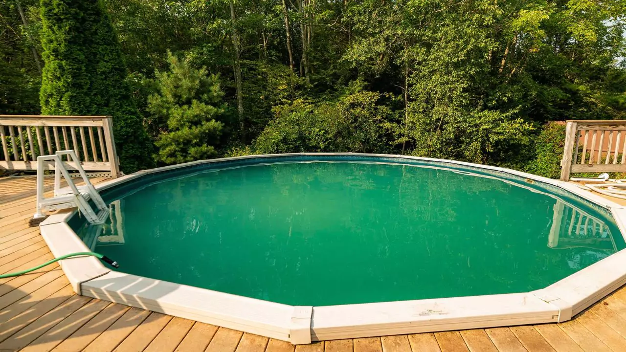 Round wooden pool sunk into decking